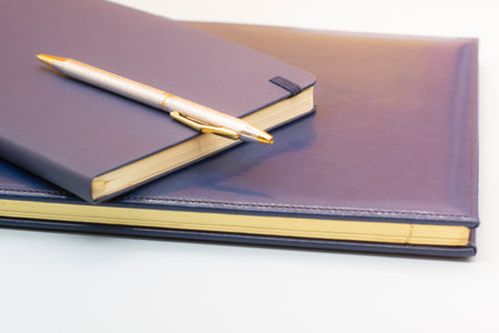 blue leather notebooks and a pen. Preparing for a business meeting. Business conceptの写真素材