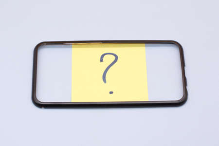 question mark in row written in marker on yellow stickersの写真素材