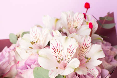 bouquet of Alstroemeria and purple roses. Fresh, lush bouquet of colorful flowersの写真素材