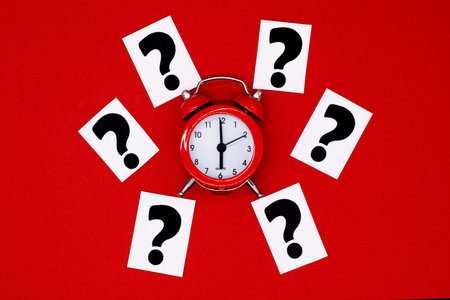 a question mark on a white sheet and a red alarm clock. FAQ frequency asked questions, Answer and...