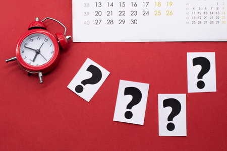 a question mark on a white sheet and a red alarm clock. FAQ frequency asked questions, Answer and...