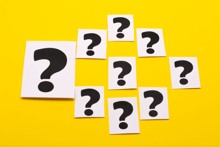 a question mark on a white sheet. FAQ frequency asked questions, Answer and Brainstorming Concepts