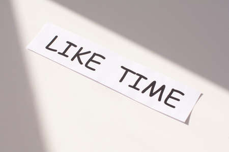 text LIKE TIME on white paper on a white background. Social conceptの写真素材