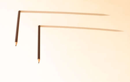 inverted black pencils stand upright and shadow. The concept of leadership and businessの写真素材