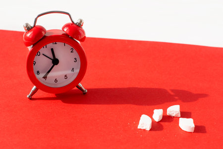 red alarm clock and pills. Time reminder for taking pills.Medicine in hospital.