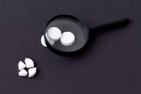 Medical pills and capsules. Isolated on a black background. A fast-dissolving, effervescent tablet, allergy pill, antibiotics. Virus and flu Diseases in Winter.の写真素材