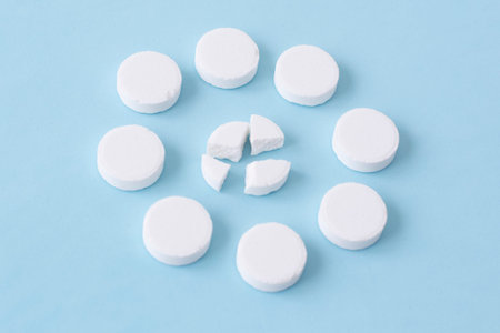 white medical pills on a blue background. Health concept