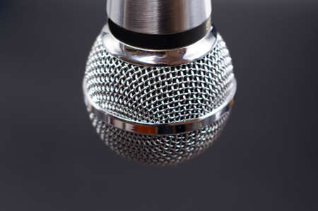 Black classic microphone on black dark background. Music concept.の写真素材