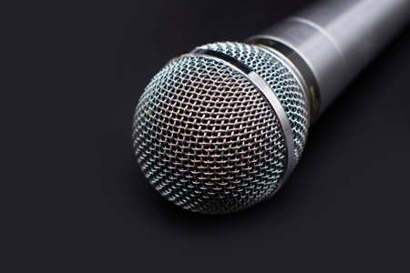 Black classic microphone on black dark background. Music concept.の写真素材