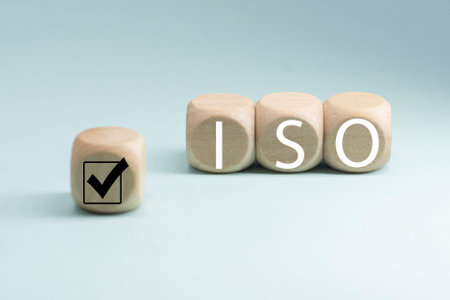 abbreviation ISO on wooden cubes with check mark. ISO quality control certification approval concept.の写真素材