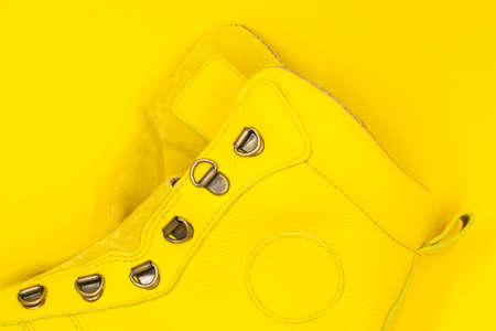 Women's yellow shoe on a yellow background. Fashion conceptの写真素材