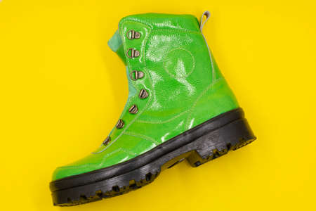 Women's green shoe on a yellow background. Fashion conceptの写真素材