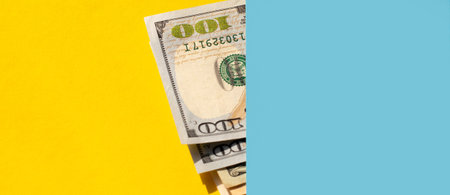 dollar bills on a yellow and blue background. Business concept.