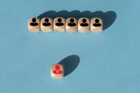 Wooden blocks with people icon on blue background. Organization structure, social network, leadership, team building, job recruitment, management or human resources concepts.の写真素材