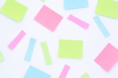 multicolored blank paper stickers of different colors on a white background, copy space
