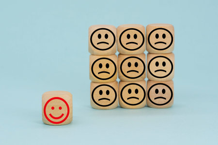 Wooden Block With Happy And Unhappy Face. Customer service rating or satisfaction concept. Business...