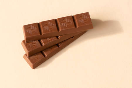 small milk chocolate bars on a yellow backgroundの写真素材