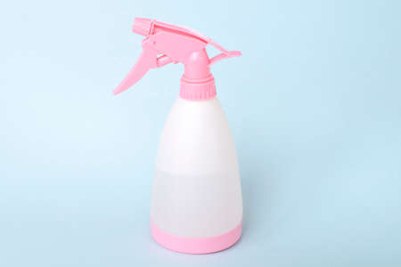 Colorful plastic spray bottle for home on a blue backgroundの写真素材