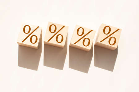 Percentage Sign on wooden cubes on a white backgroundの写真素材