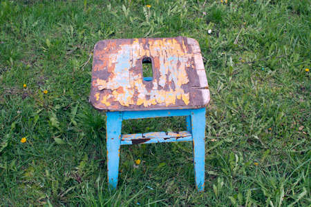 an old wooden stool on the green grassの写真素材