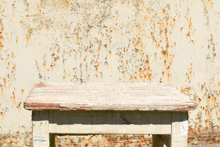 wooden chair on the background of the old metal gateの写真素材