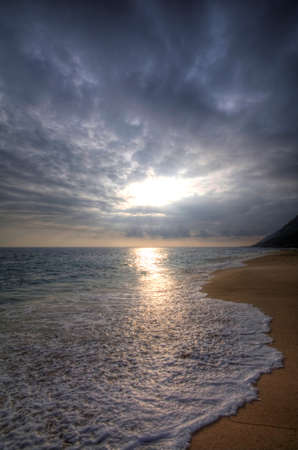 Amazing sunrise on the beach by the seaの写真素材