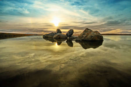 Blocks of stone in a shallow lakeの写真素材
