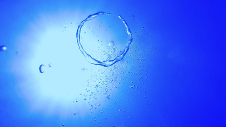Group of bubbles ascending in a blue clear sea