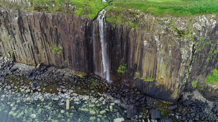 Impressive coastline on the cliffs with a bewitching waterfall