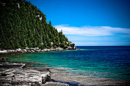 Ocean shore at the foot of the mountainの写真素材