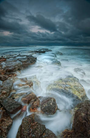 Stone rocks washed by a stormy oceanの写真素材