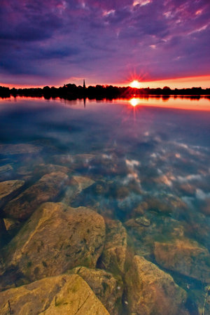 Sunset and clear lake in the evening