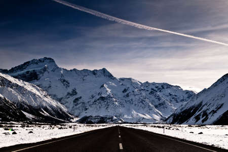 Snowy mountains and clean asphaltの写真素材