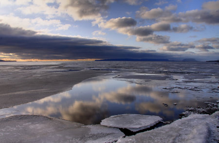 Gray huge ice floes against a blue skyの写真素材