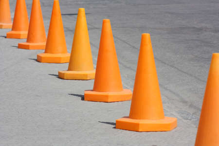 Orange cone. Road warning signs standing in a rowの写真素材