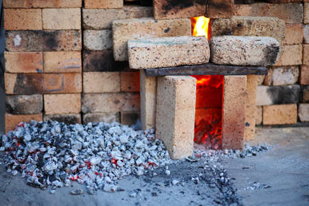 Oven of bricks  A handful of coal near the stoveの写真素材