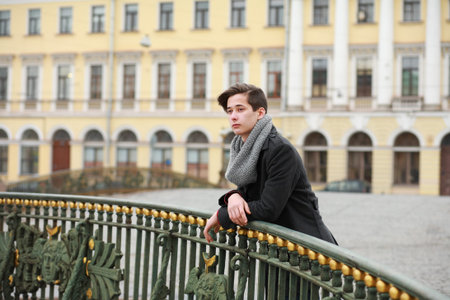 Young man posing in the street in the background architecture, St. Petersburg