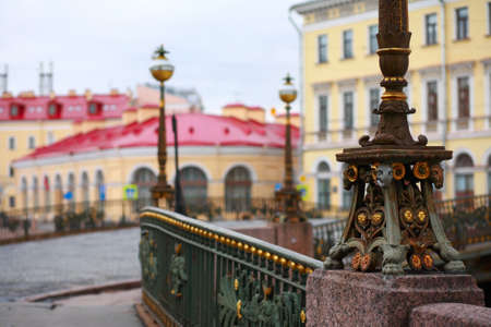 St. Petersburg, Russia, fragments of architecture. The base of a street lamp on the Theatrical bridge on the background of buildingsの写真素材