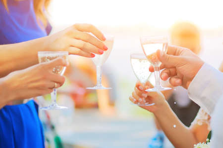 Glasses of champagne in handsの写真素材