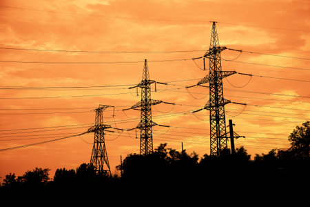 High-voltage networks, silhouettes at sunset