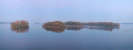 Panorama, islands at sunrise in the fog on the Dnieper River