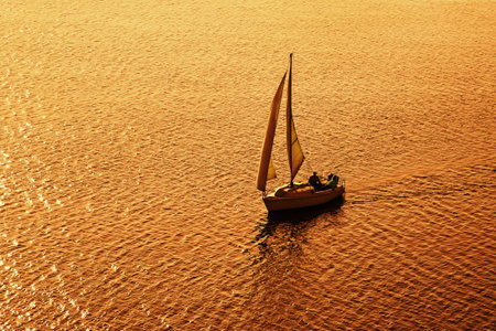Sailboat at sunset, silhouette in backlight