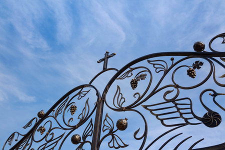 Church forged gate against the sky