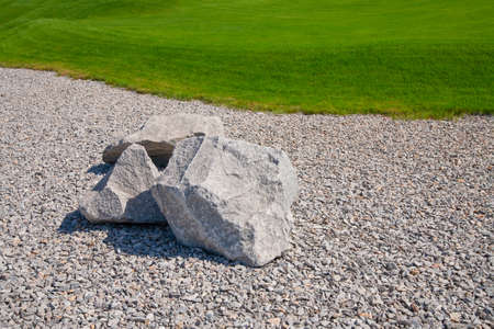 Landscaping, stones on gravel and lawnの写真素材