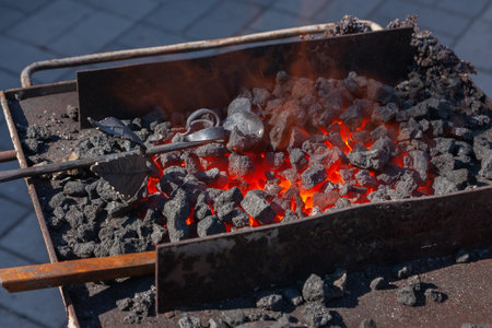 Forge, brazier with hot coals, equipment close-up