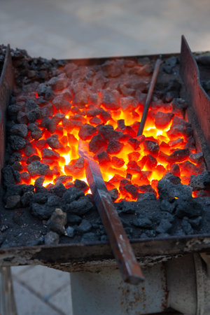 Forge, brazier with hot coals, equipment close-up