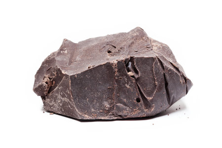 Large piece of raw, dark chocolate isolated on white backgroundの写真素材