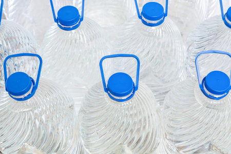 Water in plastic bottles on a white background, isolated