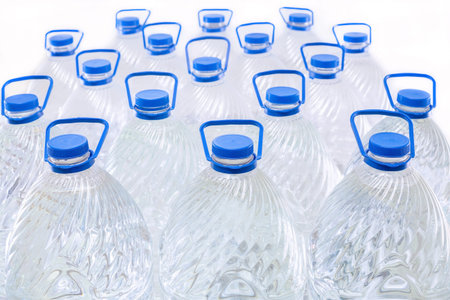 Water in plastic bottles on a white background, isolated