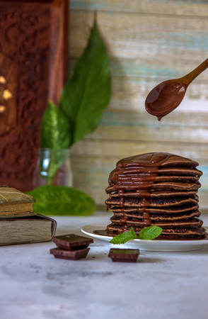 Chocolate pancakes with syrup for dessert or breakfast.の写真素材